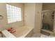Bathroom featuring a tub, shower and a glass block window offering natural light at 318 Muirfield Rd., Myrtle Beach, SC 29588