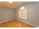This bedroom features wood flooring and a large window, offering bright space at 318 Muirfield Rd., Myrtle Beach, SC 29588