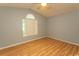 Bright bedroom features laminated wood flooring and a large window offering natural light at 318 Muirfield Rd., Myrtle Beach, SC 29588