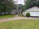 Charming one-story brick home with well-manicured lawn and mature trees at 318 Muirfield Rd., Myrtle Beach, SC 29588