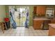 Bright kitchen featuring sliding glass doors, wooden cabinets and tile floors at 318 Muirfield Rd., Myrtle Beach, SC 29588