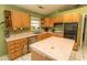 Well-lit kitchen with tile flooring, wooden cabinets, and stainless-steel appliances at 318 Muirfield Rd., Myrtle Beach, SC 29588