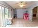 Living area with tile flooring, pink playhouse, and slider to outside, perfect for entertaining at 318 Muirfield Rd., Myrtle Beach, SC 29588