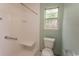 Shower stall featuring a grab bar, seating, and neutral tiling at 318 Muirfield Rd., Myrtle Beach, SC 29588