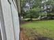 Backyard area enclosed by a chain link fence and green trees at 331 Dixon St., Mullins, SC 29574
