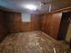 Bedroom features damaged ceiling, wood paneling, and a window at 331 Dixon St., Mullins, SC 29574