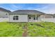 Home's backyard offers a covered patio and manicured lawn with minimal landscaping at 346 High Falls Dr., Conway, SC 29526