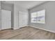 A neutral bedroom showcasing wood-look floors, bright window, and ample closet space at 346 High Falls Dr., Conway, SC 29526