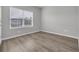Neutral bedroom showcasing wood-look floors, bright window, and calming paint at 346 High Falls Dr., Conway, SC 29526