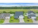 Aerial view of home with green lawn, landscaping, and driveway in a suburban neighborhood at 346 High Falls Dr., Conway, SC 29526