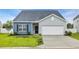 Charming single-story home features a two-car garage, manicured lawn, and stylish curb appeal at 346 High Falls Dr., Conway, SC 29526