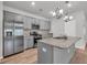 Well-equipped kitchen with stainless steel appliances, granite countertops, and gray cabinets with stylish lighting at 346 High Falls Dr., Conway, SC 29526