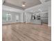 Open-concept living space featuring wood flooring, a tray ceiling, and a modern kitchen with stainless steel appliances at 346 High Falls Dr., Conway, SC 29526