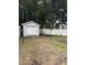 A detached garage in the backyard with a white fence at 3534 Gordon Dr., Myrtle Beach, SC 29579