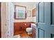 Neat bathroom featuring a window, wood paneling, and standard fixtures at 401 Harmon Park Blvd., Marion, SC 29571