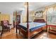 Well-lit bedroom featuring a four-poster bed, hardwood floors, and ample natural light at 401 Harmon Park Blvd., Marion, SC 29571