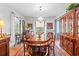 Traditional dining room with hardwood floors, large wooden table, china cabinet, and plenty of natural light at 401 Harmon Park Blvd., Marion, SC 29571