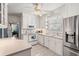 Bright, all-white kitchen with lots of storage and natural light, stainless steel appliances, and a view to the breakfast nook at 401 Harmon Park Blvd., Marion, SC 29571