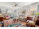 Bright living room featuring hardwood floors, many windows, comfortable seating, ceiling fan, and a colorful area rug at 401 Harmon Park Blvd., Marion, SC 29571