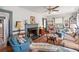 Inviting living room with a cozy fireplace, ceiling fan, lots of natural light, and comfortable seating at 401 Harmon Park Blvd., Marion, SC 29571