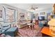 A cozy living room with hardwood floors, large windows, ceiling fan, and access to the Primary bedroom at 401 Harmon Park Blvd., Marion, SC 29571