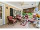 Relaxing screened porch with wicker furniture and a ceiling fan at 401 Harmon Park Blvd., Marion, SC 29571