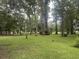 Large green lawn with mature trees and plenty of open space at 401 Harmon Park Blvd., Marion, SC 29571