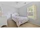 Cozy bedroom features a bright window, plush carpet, and a stylish bed frame with a decorative comforter at 402 Bristlecone St., Longs, SC 29568