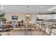 Open living and dining area with stylish furnishings, a kitchen bar and plenty of space for entertaining at 4142 Hibiscus Dr. # 102, Little River, SC 29566