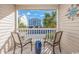 Comfortable balcony with seating provides views of the neighborhood, beach, and palm trees at 4201 N Ocean Blvd. # Ocean View, Myrtle Beach, SC 29572