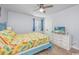 Cozy bedroom with a ceiling fan, TV, and a cheerful, colorful bedspread at 4201 N Ocean Blvd. # Ocean View, Myrtle Beach, SC 29572