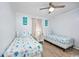 Bright bedroom featuring twin beds, beach-themed decor, and wood-look flooring at 4201 N Ocean Blvd. # Ocean View, Myrtle Beach, SC 29572