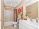 Bathroom with shower-tub combo, decorated with orange-themed decor at 4366 Rivergate Ln. # 306, Little River, SC 29566