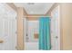 Bathroom with a shower-tub combo, tile surround, and a white door at 4366 Rivergate Ln. # 306, Little River, SC 29566