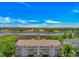 Beautiful condo building featuring white balconies overlooking a tranquil river view and lush scenery at 4366 Rivergate Ln. # 306, Little River, SC 29566