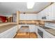Well-lit kitchen with white cabinetry, laminate countertops, and stainless steel appliances at 4366 Rivergate Ln. # 306, Little River, SC 29566