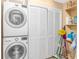 This laundry room has a stacked washer and dryer set next to a closet at 4366 Rivergate Ln. # 306, Little River, SC 29566