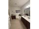 Bright bathroom featuring a soaking tub, double vanity with ample storage, and neutral tile flooring at 448 Mahogany Dr. # 201, Murrells Inlet, SC 29576