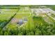 Expansive aerial view of the property featuring a white home, a barn and sprawling green space at 4486 Bethel Rd., Aynor, SC 29511