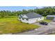 Aerial view of white exterior home with attached garage on a large lot with green lawn at 4486 Bethel Rd., Aynor, SC 29511