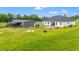 The backyard has a large grassy area for recreation, with outbuildings, a patio and play equipment at 4486 Bethel Rd., Aynor, SC 29511