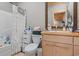 Bathroom showcasing wood-framed mirror, wooden vanity with sink, and a tub with shower and shower curtain at 4486 Bethel Rd., Aynor, SC 29511