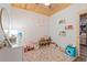 Charming bedroom with unique wallpaper, wooden ceiling, built-in bookshelves and ample toy storage at 4486 Bethel Rd., Aynor, SC 29511
