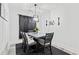 Formal dining room area featuring contemporary lighting, seating for six, and dark accents at 4486 Bethel Rd., Aynor, SC 29511