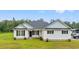 Charming home with white siding, black shutters, well-manicured lawn and inviting front entrance at 4486 Bethel Rd., Aynor, SC 29511
