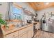 Functional kitchen boasts natural wood counters, stainless steel refrigerator and ample shelving and cabinet space at 4486 Bethel Rd., Aynor, SC 29511