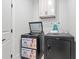 Laundry room with modern black appliances, upper cabinets, and folding space at 4486 Bethel Rd., Aynor, SC 29511