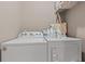 Convenient laundry area featuring a modern washer and dryer set, storage shelves, and cleaning supplies at 4486 Bethel Rd., Aynor, SC 29511