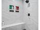 Modern shower with marble-look tile, black hardware, built-in niche shelving, and a seating bench at 4486 Bethel Rd., Aynor, SC 29511