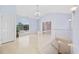 Light-filled entryway with hardwood floors, arched window, staircase, and neutral color palette at 4552 River Rd., Little River, SC 29566